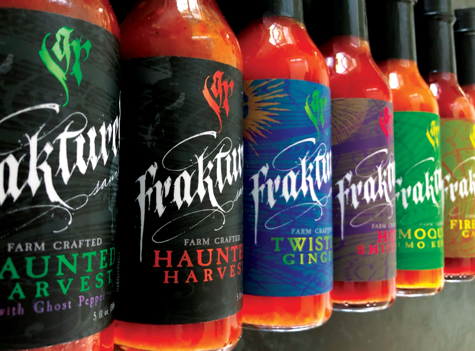 Full lineup of Fraktured Sauce hot pepper sauces made from small farm grown peppers